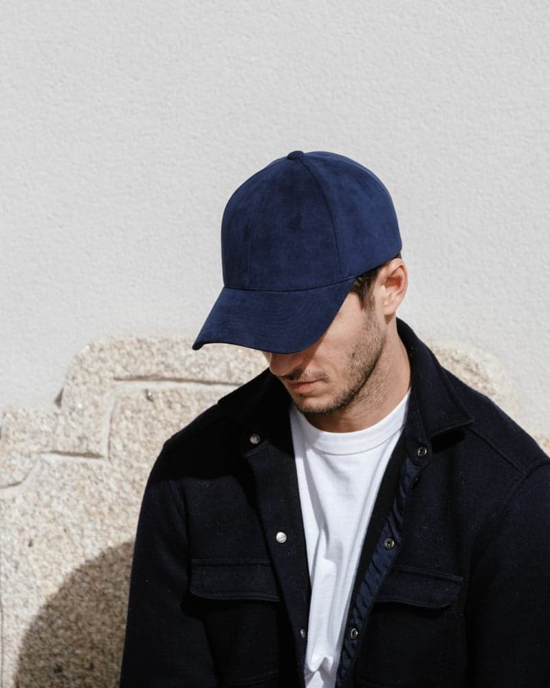 Front view of a male model wearing a legacy structured commodore blue alcantara cap